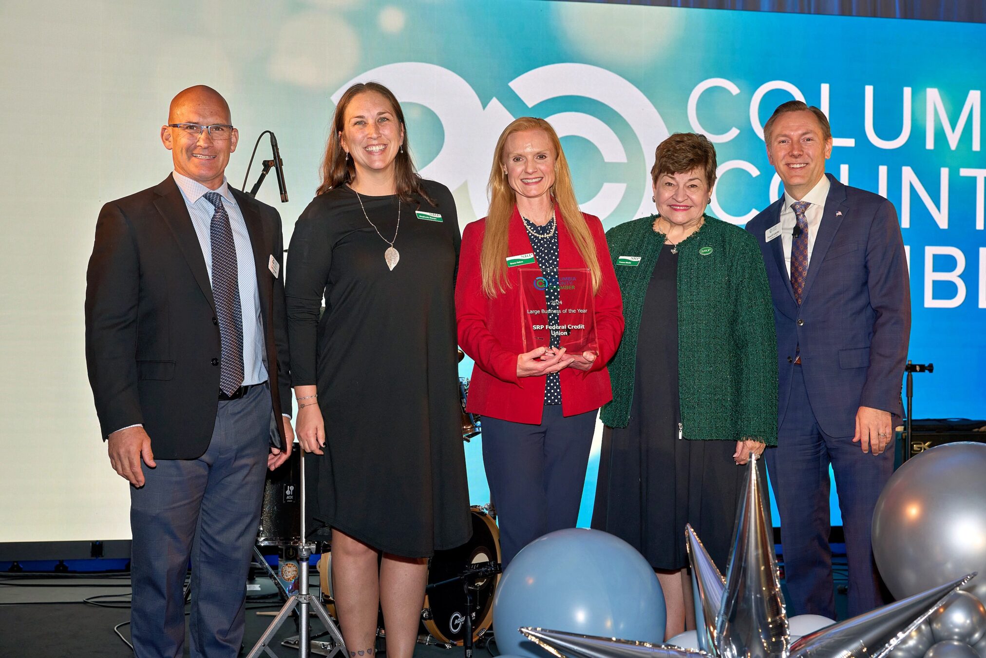 SRP team members join representatives of the Columbia County Chamber of Commerce on stage to accept the 2024 Large Business of the Year award.