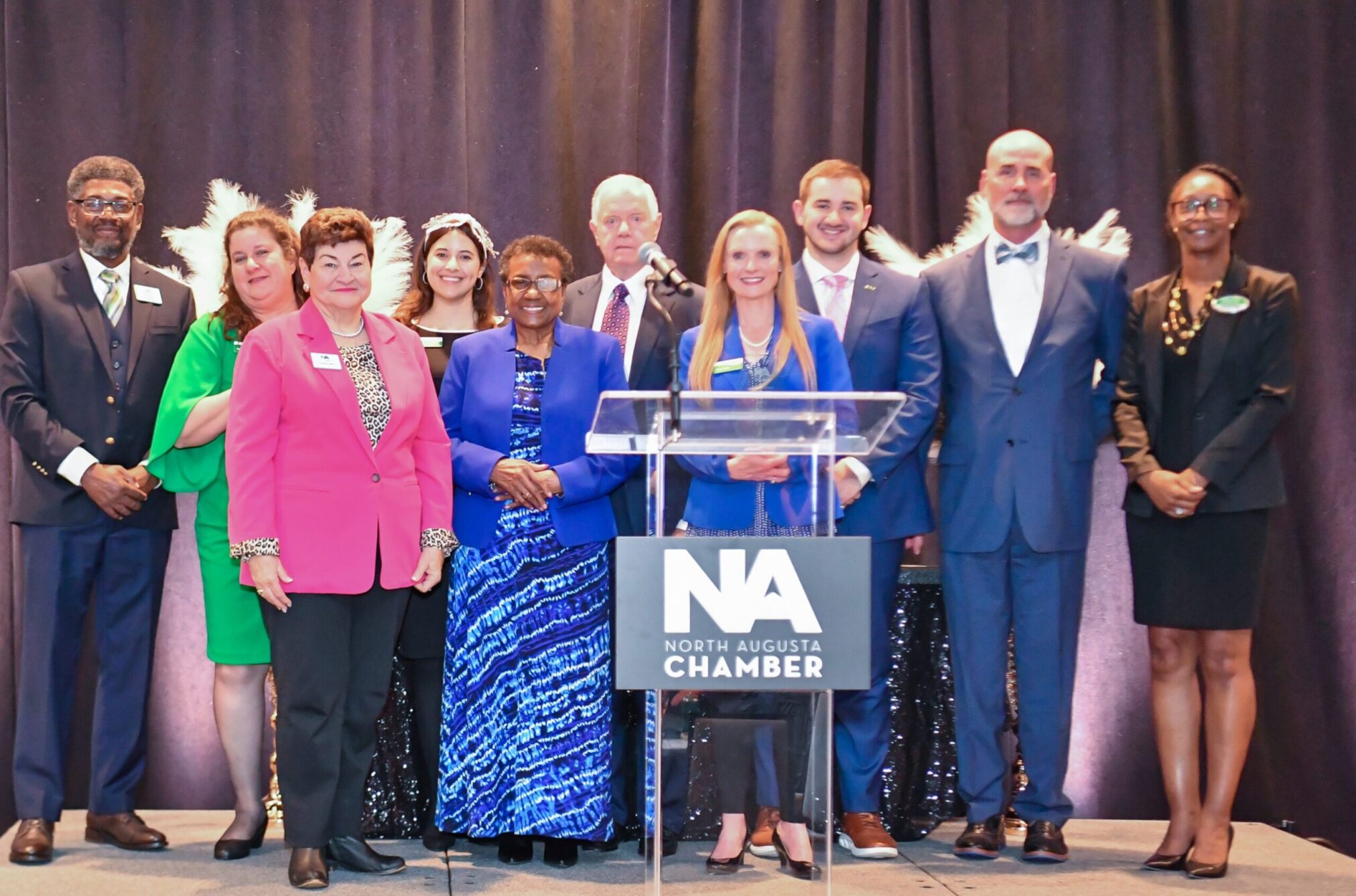 SRP team members and representatives of the North Augusta Chamber of Commerce pose for a photo on stage at the chamber's annual meeting and awards gala.