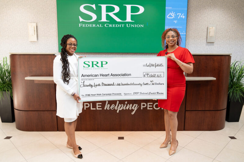 Ieshia Bell and Charmaine Finch, chair and co-chair of SRP's American Heart Assocation fundraising campaign, hold a ceremonial check for over $45,000.