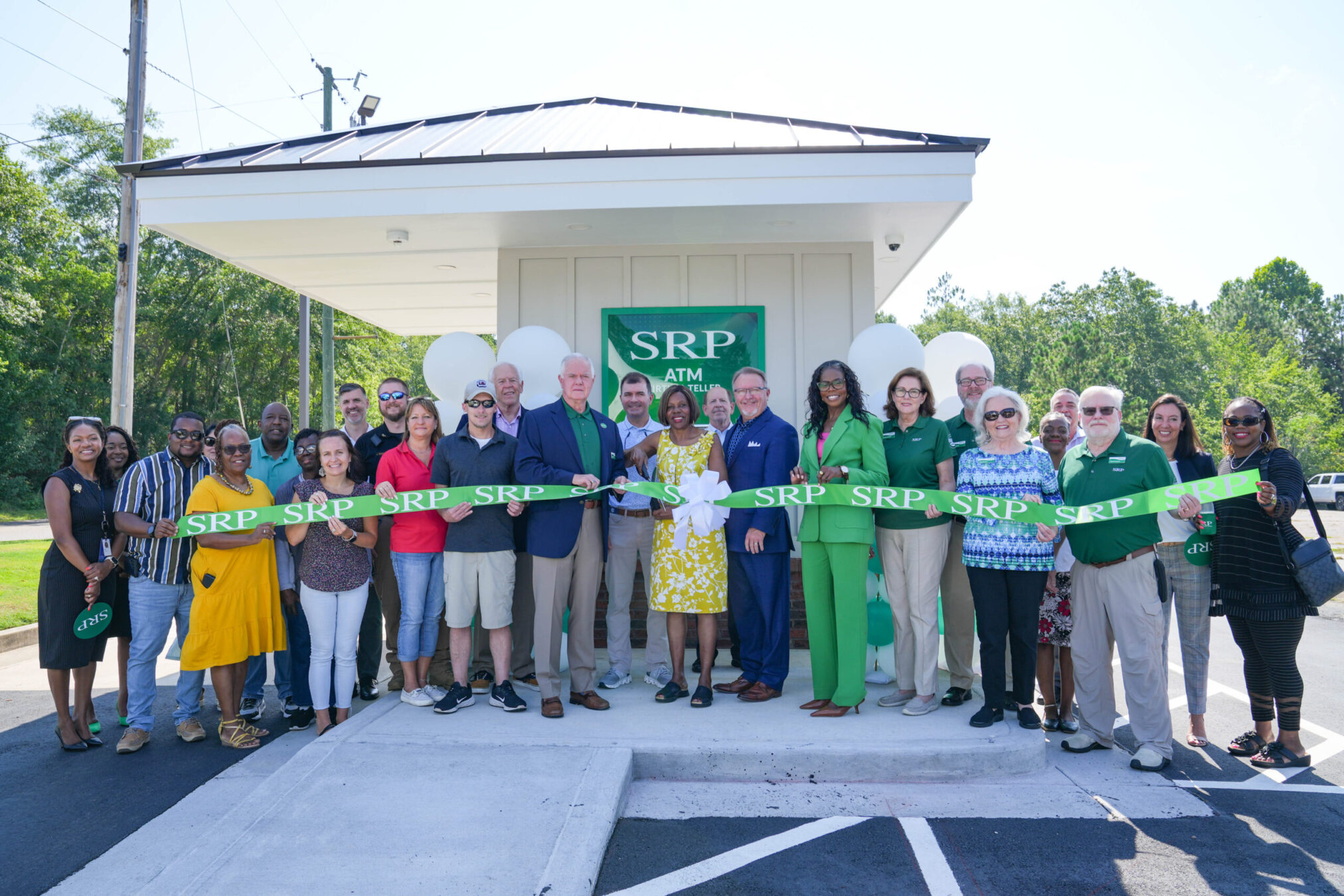 2025-0711-newellenton-atm (125) Representatives of SRP Federal Credit Union join community leaders, community members, and elected officials in a ribbon-cutting ceremony in front of a newly built Virtual Teller ATM in New Ellenton, South Carolina.