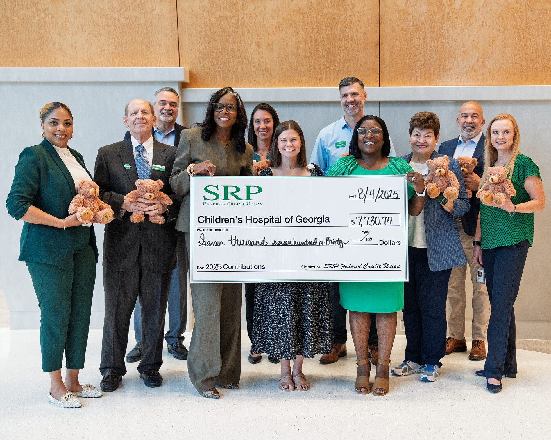 CHOG Check Presentation (4.5 ratio) Representatives of SRP Federal Credit Union join Kelsey McCullough of the Children's Hospital of Georgia with a ceremonial check for $7,730.74.