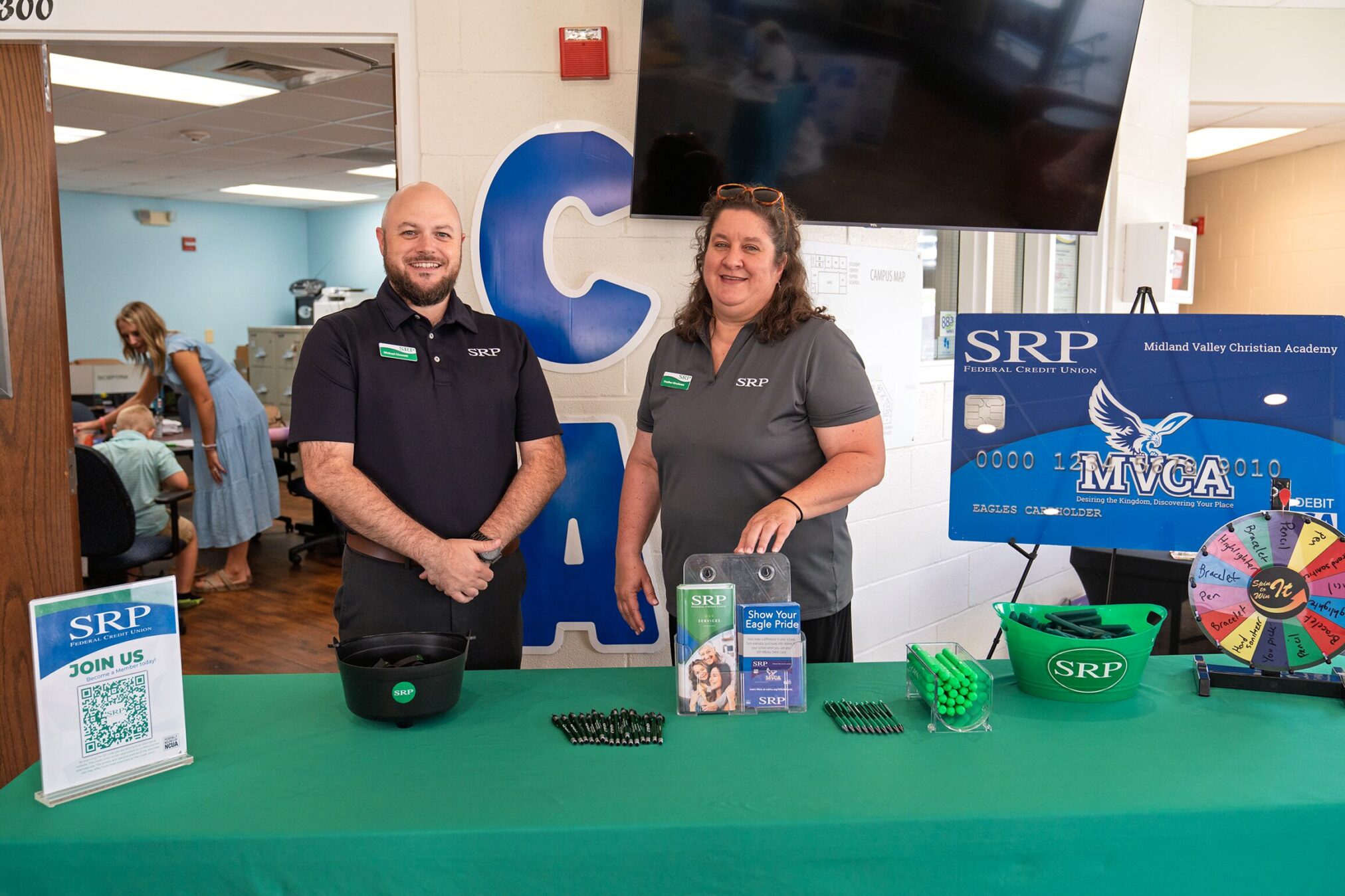 MVCA table SRP team members Michael Clennett and Heather Hirschman promote the SRP Affinity Debit Card Program and give away SRP swag items at Midland Valley Christian Academy,
