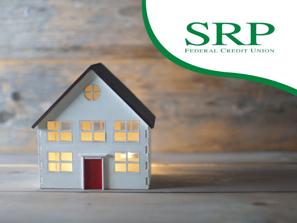 Buying vs. renting a home Which is right for your wallet and lifestyle A small model of a house is next to the credit union's logo.