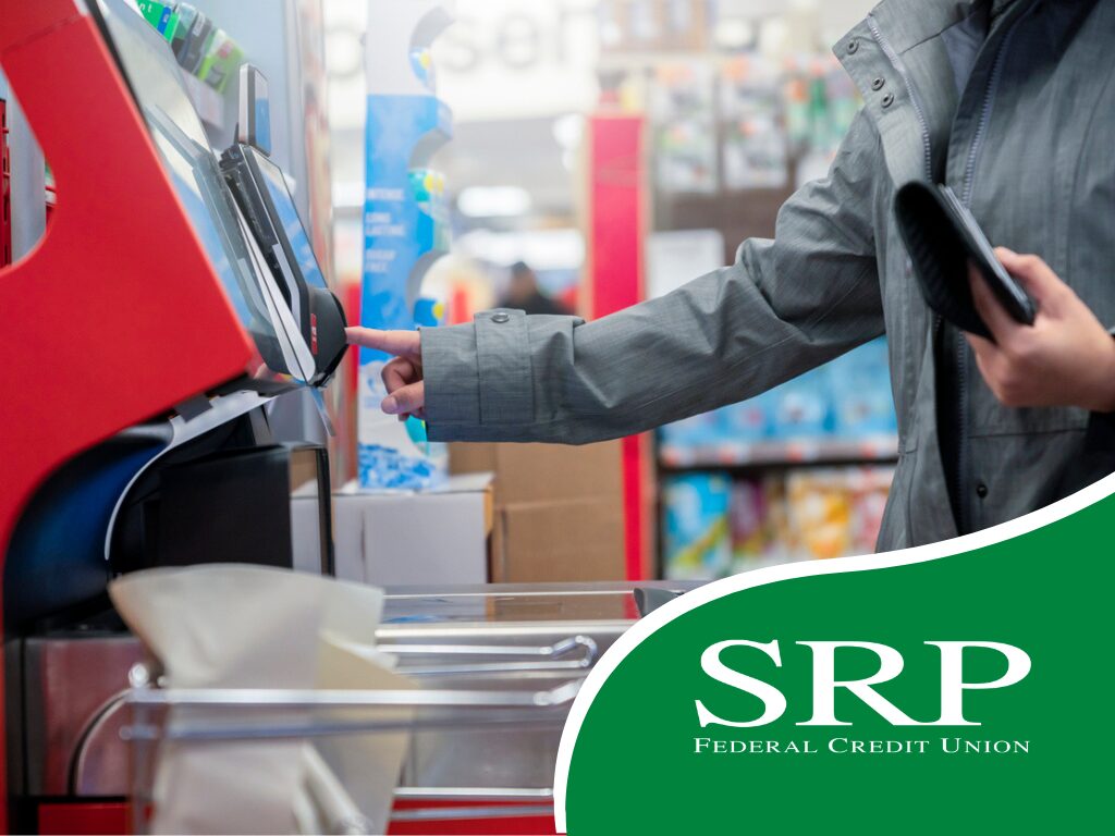 A shopper uses a self-checkout machine.