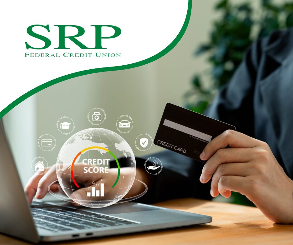 A businesswoman uses a credit card and a laptop.