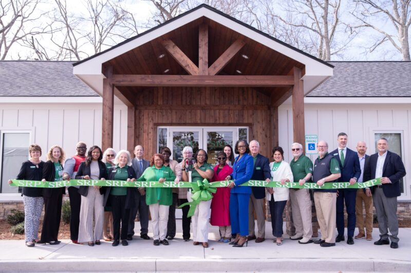 SRP and community leaders pose for a ribbon-cutting ceremony photo in front of SRP Federal Credit Union's new Allendale, SC branch.