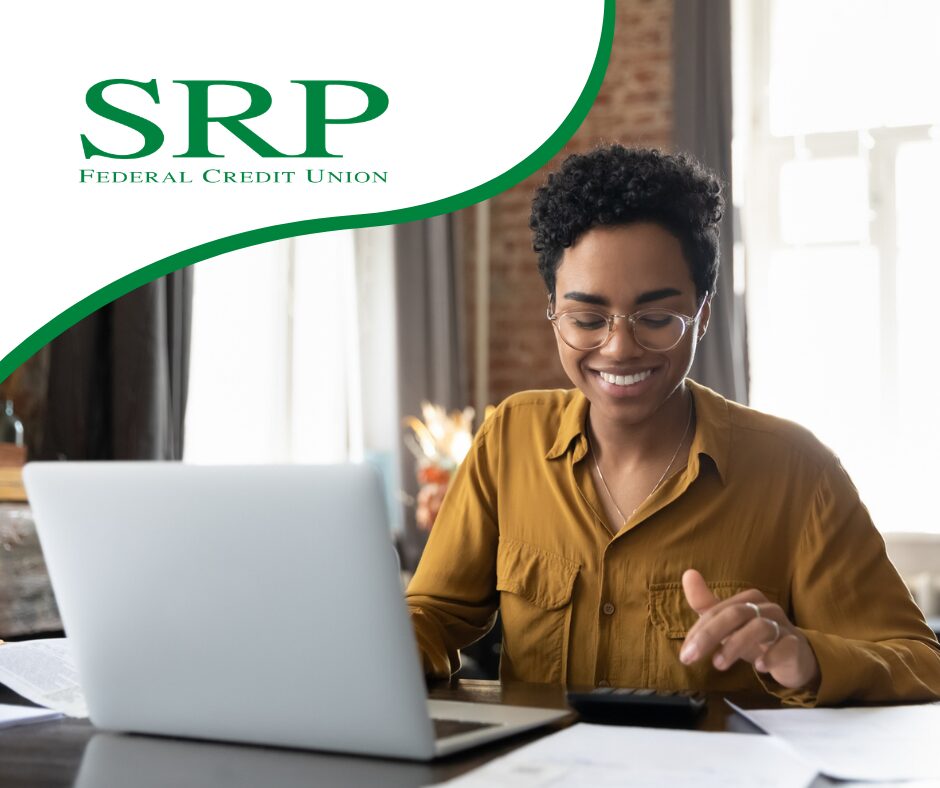 A young woman manages her taxes at a laptop,