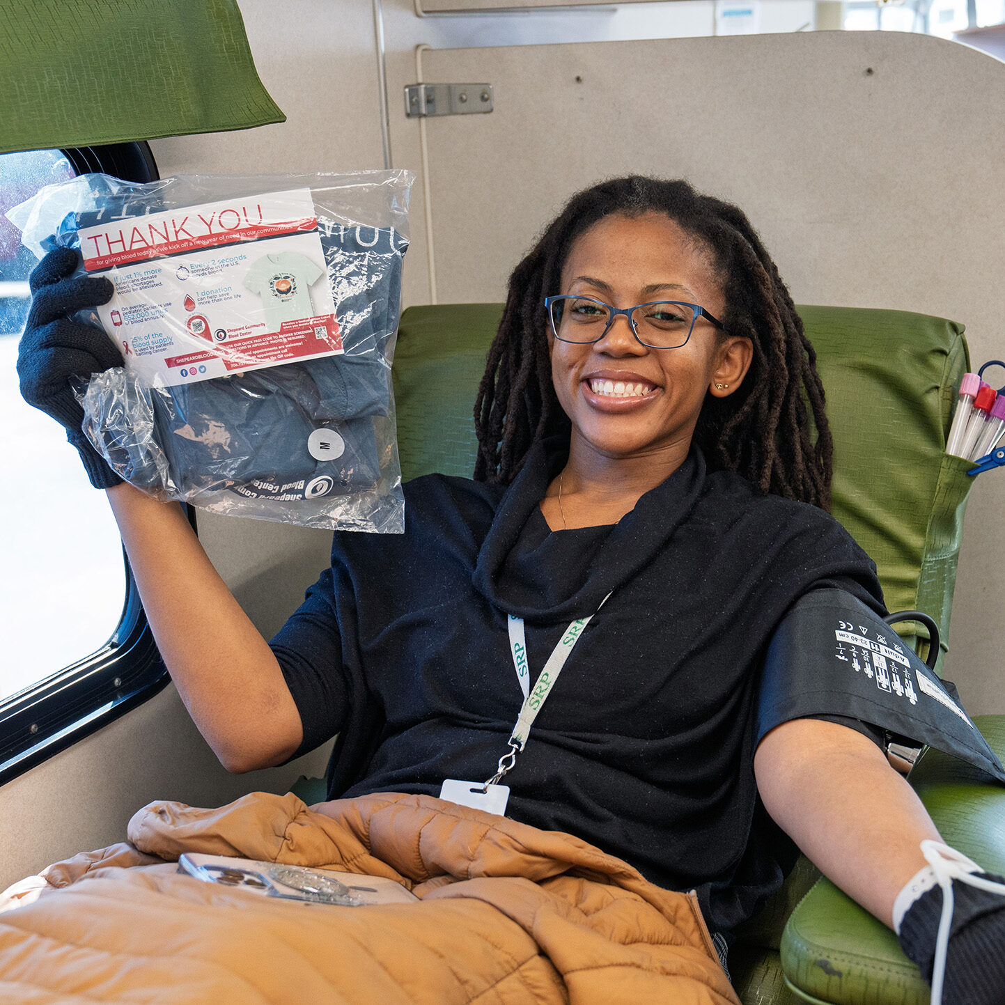 An SRP ambassador prepares to donate blood inside the Bloodmobile.