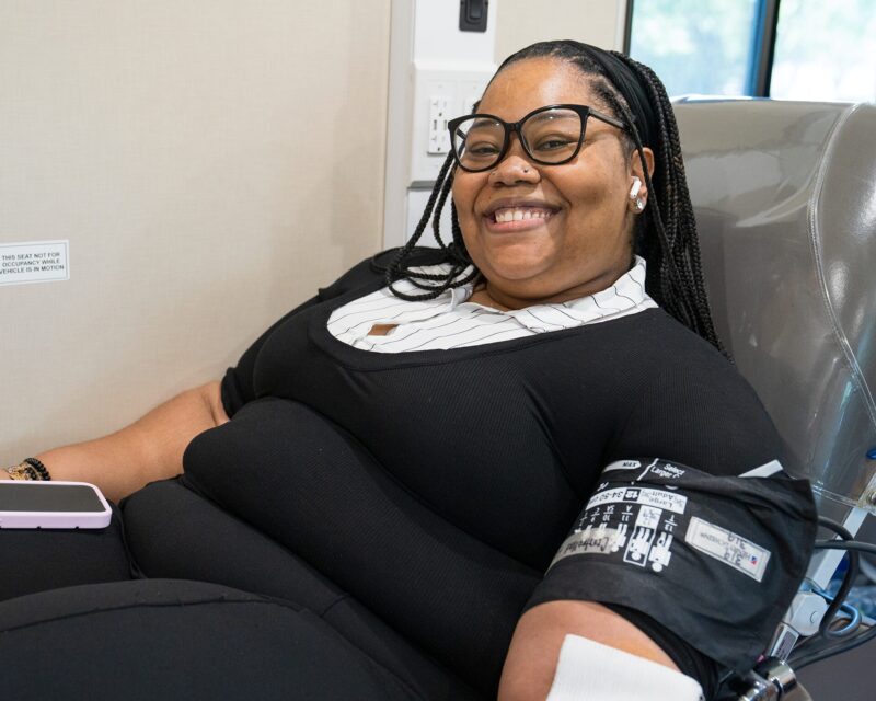A woman donates inside one of Shepeard's Bloodmobiles.