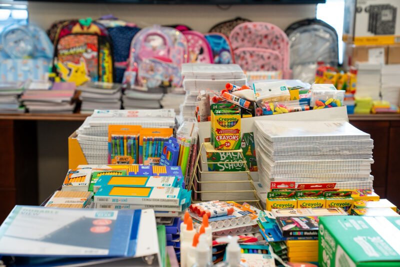 Crayons, notebooks, backpacks, and other school supplies fill a conference room at SRP Federal Credit Union. SRP employees donated the supplies for the United Way Stuff the Bus campaign.