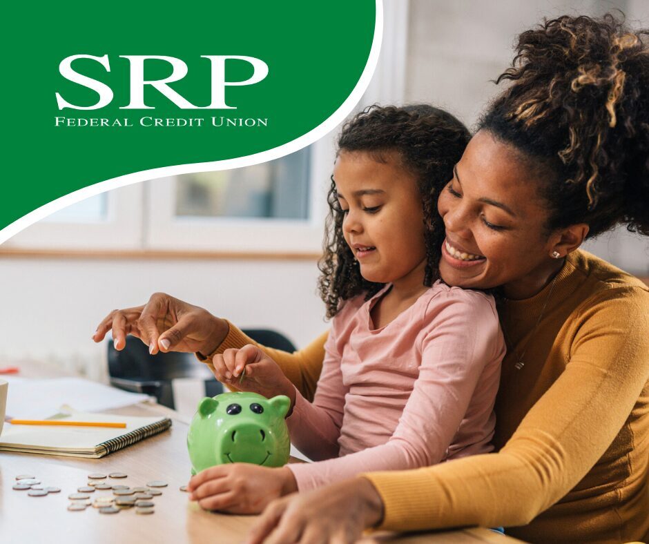 April - Teaching kids and teens smart money habits A mother teaches her daughter smart money habits with a piggy bank for savings.