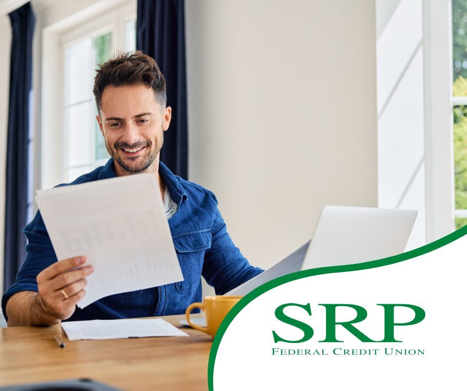 March - Daily habits that make building wealth easier A man focused on building wealth smiles at his paperwork.