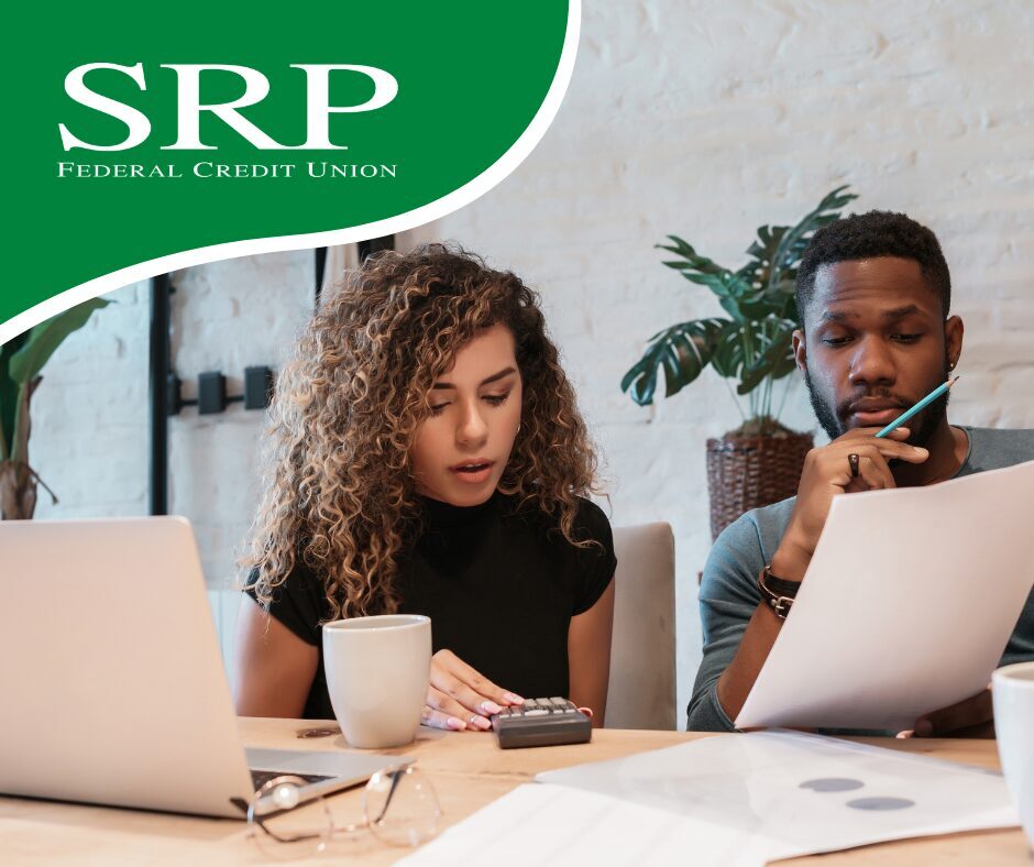 Retirement Planning How to Get Started A young couple looks at a laptop and print-outs as they start planning for retirement.