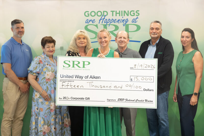 A group of SRP and United Way representatives holds a ceremonial check for $15,000.