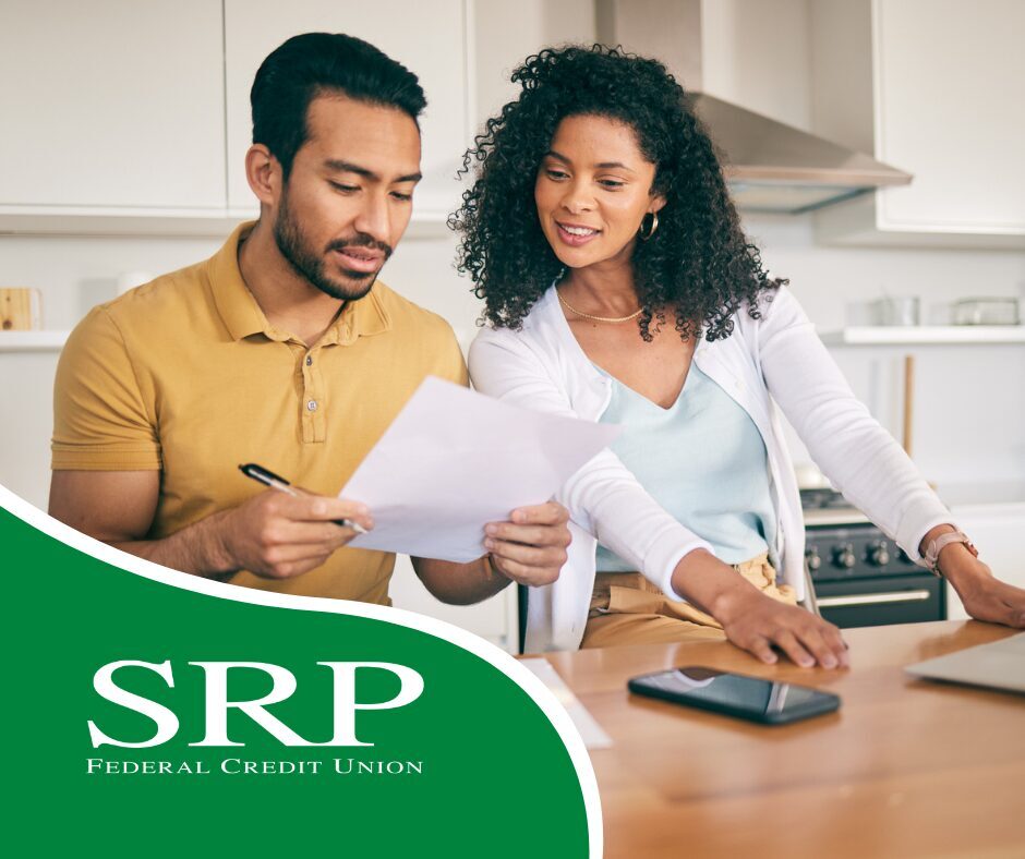Saving Money at Home Two people at home work on saving money.